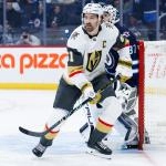 Jan 6, 2026; Winnipeg, Manitoba, CAN; Vegas Golden Knights forward Mark Stone (61) and Winnipeg Jets goalie Connor Hellebuyck (37) look for the puck during the first period at Canada Life Centre. Mandatory Credit: Terrence Lee-Imagn Images