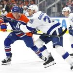 Mar 21, 2026; Edmonton, Alberta, CAN; Edmonton Oilers forward Josh Samanski (81) and Tampa Bay Lightning forward Zemgus Girgensons (28) chase a loose puck during the third period at Rogers Place. Mandatory Credit: Perry Nelson-Imagn Images