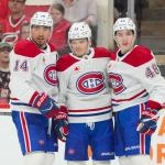 Mar 29, 2026; Raleigh, North Carolina, USA; Montreal Canadiens center Nick Suzuki (14) is congratulated by defenseman Lane Hutson (48) and right wing Cole Caufield (13) after his goal against the Carolina Hurricanes during the second period at Lenovo Center. Mandatory Credit: James Guillory-Imagn Images