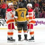 Apr 2, 2026; Las Vegas, Nevada, USA; Vegas Golden Knights defenseman Rasmus Andersson (4) talks with Calgary Flames center Mikael Backlund (11) an left wing Blake Coleman (20) as repairs are made to the ice before the start of the third period at T-Mobile Arena. Mandatory Credit: Stephen R. Sylvanie-Imagn Images