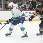 Oct 21, 2025; Pittsburgh, Pennsylvania, USA; Vancouver Canucks left wing Evander Kane (91) skates with the puck ahead of Pittsburgh Penguins defenseman Caleb Jones (82) during the first period at PPG Paints Arena. Mandatory Credit: Charles LeClaire-Imagn Images