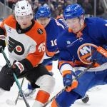 Apr 3, 2026; Elmont, New York, USA; Philadelphia Flyers forward Trevor Zegras (46) and New York Islanders fordward Mathew Barzal (13) battle for a puck during the third period at UBS Arena. Mandatory Credit: Alexander Wohl-Imagn Images