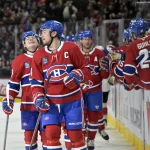 Apr 1, 2025; Montreal, Quebec, CAN; Montreal Canadiens forward Nick Suzuki (14) celebrates with teammates including forward Cole Caufield (13) after scoring a goal against the Florida Panthers during the third period at the Bell Centre.