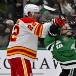Apr 7, 2026; Dallas, Texas, USA; Calgary Flames center Ryan Strome (22) checks Dallas Stars center Justin Hryckowian (49) during the second period at the American Airlines Center.