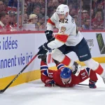 Apr 7, 2026; Montreal, Quebec, CAN; Florida Panthers defenseman Gustav Forsling (42) takes the puck away from Montreal Canadiens forward Nick Suzuki (14) during the overtime period at the Bell Centre. Mandatory Credit: Eric Bolte-Imagn Images