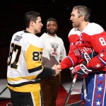 Feb 23, 2020; Washington, District of Columbia, USA; Pittsburgh Penguins center Sidney Crosby (87) shakes hands with Washington Capitals left wing Alex Ovechkin (8) after participating in a ceremonial puck drop with former Capital Joel Ward (M) prior to Black History Game at Capital One Arena. Mandatory Credit: Geoff Burke-Imagn Images