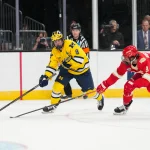 Apr 9, 2026; Las Vegas, Nevada, UNITED STATES; Michigan Wolverines forward Nick Moldenhauer (9) moves the puck while defended by Denver Pioneers defenseman Boston Buckberger (9) in the third period in the semifinals of the NCAA men\'s ice hockey Frozen Four at T-Mobile Arena. Mandatory Credit: Lucas Peltier-Imagn Images