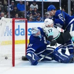 Oct 18, 2025; Toronto, Ontario, CAN; Toronto Maple Leafs defenseman Brandon Carlo (25) battles with Seattle Kraken left wing Jaden Schwartz (17) as the puck goes past goaltender Anthony Stolarz (41) for a goal during the second period at Scotiabank Arena. Mandatory Credit: Nick Turchiaro-Imagn Images