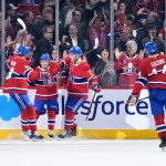 Mar 24, 2026; Montreal, Quebec, CAN; Montreal Canadiens forward Cole Caufield (13) celebrates with teammates after scoring a goal against the Carolina Hurricanes during the second period at the Bell Centre.