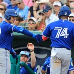 Feb 22, 2026; Fort Myers, Florida, USA; Toronto Blue Jays designated hitter Eloy Jimenez (74) scores a run by Toronto Blue Jays catcher Brandon Valenzuela (59) sacrifice hit at JetBlue Park at Fenway South.
