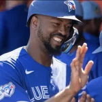 Feb 25, 2026; Lakeland, Florida, USA; Toronto Blue Jays outfielder Eloy Jiménez (74)  high-fives in the dugout at Publix Field at Joker Marchant Stadium.