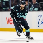 Jan 21, 2026; Seattle, Washington, USA; Seattle Kraken forward Matty Beniers (10) skates with the puck against the New York Islanders at Climate Pledge Arena. Mandatory Credit: Stephen Brashear-Imagn Images