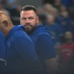 Apr 7, 2026; Toronto, Ontario, CAN; Toronto Blue Jays manager John Schneider (14) looks back towards the dugout as he lines up for the pre-game national anthems before playing the Los Angeles Dodgers at Rogers Centre.