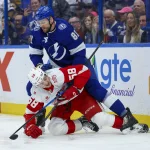 Apr 13, 2026; Tampa, Florida, USA; Tampa Bay Lightning defenseman Erik Cernak (81) holds down Detroit Red Wings center Emmitt Finnie (58) in the second period at Benchmark International Arena. Mandatory Credit: Nathan Ray Seebeck-Imagn Images