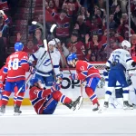 Apr 9, 2026; Montreal, Quebec, CAN; Montreal Canadiens forward Juraj Slafkovsky (20) celebrates with teammates including forward Cole Caufield (13) after scoring a goal against the Tampa Bay Lightning during the third period at the Bell Centre. Mandatory Credit: Eric Bolte-Imagn Images