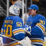Apr 14, 2026; St. Louis, Missouri, USA; St. Louis Blues goaltender Joel Hofer (30) congratulates goaltender Jordan Binnington (50) after defeating the Pittsburgh Penguins at Enterprise Center. Mandatory Credit: Connor Hamilton-Imagn Images