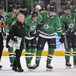 Mar 6, 2026; Dallas, Texas, USA; Dallas Stars center Roope Hintz (24) is helped off the ice by left wing Jason Robertson (21) and defenseman Esa Lindell (23) and defenseman Miro Heiskanen (4) after being injured during the game between the Stars and the Avalanche at American Airlines Center. Mandatory Credit: Jerome Miron-Imagn Images