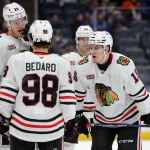Mar 24, 2026; Elmont, New York, USA; Chicago Blackhawks center Anton Frondell (15) talks to center Connor Bedard (98) and defenseman Alex Vlasic (72) during the third period at UBS Arena. Mandatory Credit: Brad Penner-Imagn Images