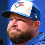 Oct 11, 2025; Toronto, Ontario, CA; Toronto Blue Jays manager John Schneider (14) speaks to the media during workouts for the American League Championship Series at Rogers Centre. Mandatory Credit: Dan Hamilton-Imagn Images