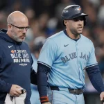 Oct 17, 2025; Seattle, Washington, USA; Toronto Blue Jays designated hitter George Springer (4) walks off the field with a trainer after being hit by a pitch against the Seattle Mariners in the seventh inning during game five of the ALCS round for the 2025 MLB playoffs at T-Mobile Park. Mandatory Credit: Stephen Brashear-Imagn Images