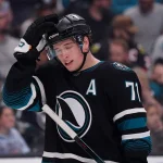 Apr 6, 2026; San Jose, California, USA; San Jose Sharks center Macklin Celebrini (71) adjusts his helmet during a break in the action against the Chicago Blackhawks in the first period at SAP Center at San Jose.