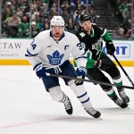 Dec 21, 2025; Dallas, Texas, USA; Toronto Maple Leafs center Auston Matthews (34) and Dallas Stars defenseman Alexander Petrovic (28) chase the puck during the game at the American Airlines Center. Mandatory Credit: Jerome Miron-Imagn Images