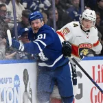 Apr 11, 2026; Toronto, Ontario, CAN; Toronto Maple Leafs forward Michael Pezzetta (61) checks Florida Panthers defenseman Marek Aischer (4) in the third period at Scotiabank Arena. Mandatory Credit: Dan Hamilton-Imagn Images