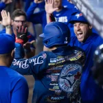 Apr 19, 2026; Phoenix, Arizona, USA; Toronto Blue Jays third baseman Kazuma Okamoto wears the home run jacket as he celebrates with teammates in the dugout after hitting a solo home run in the third inning against the Arizona Diamondbacks at Chase Field. Mandatory Credit: Mark J. Rebilas-Imagn Images