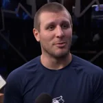 Toronto Blue Jays centerfielder Daulton Varsho speaking with reporters in the clubhouse.