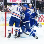Dec 13, 2025; Toronto, Ontario, CAN; Edmonton Oilers left wing Zach Hyman (18) battles either Toronto Maple Leafs defenseman Troy Stecher (28) in front of the net during the second period at Scotiabank Arena. Mandatory Credit: Nick Turchiaro-Imagn Images