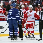Dec 31, 2016; Toronto, ON, Canada; Detroit Red Wings forward Kris Draper (33) exchanges heated words with Toronto Maple Leafs forward Gary Roberts (7) in the third period during the 2017 Rogers NHL Centennial Classic Alumni Game at BMO Field. The Red Wings beat the Maple Leafs 4-3. Mandatory Credit: Tom Szczerbowski-Imagn Images