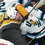 Apr 19, 2026; Las Vegas, Nevada, USA; Vegas Golden Knights center Colton Sissons (10) holds Utah Mammoth defenseman Sean Durzi (50) behind the Mammoth net during the third period of game one of the first round of the 2026 Stanley Cup Playoffs at T-Mobile Arena. Mandatory Credit: Stephen R. Sylvanie-Imagn Images