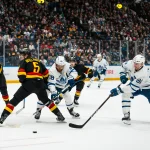 Jan 31, 2026; Vancouver, British Columbia, CAN; Vancouver Canucks forward Elias Pettersson (40) watches as defenseman Tom Willander (5) battles with Toronto Maple Leafs forward William Nylander (88) and forward John Tavares (91) in the third period at Rogers Arena. Mandatory Credit: Bob Frid-Imagn Images