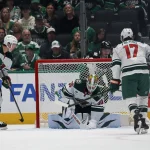 Apr 18, 2026; Dallas, Texas, USA; Minnesota Wild goaltender Jesper Wallstedt (30) freezes the puck against the Dallas Stars in the third period in game one of the first round of the 2026 Stanley Cup Playoffs at American Airlines Center.