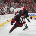 Apr 18, 2026; Raleigh, North Carolina, USA; Ottawa Senators defenseman Artem Zub (2) checks Carolina Hurricanes center Seth Jarvis (24) during the second period in game one of the first round of the 2026 Stanley Cup Playoffs at Lenovo Center.
