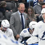 Mar 7, 2026; Toronto, Ontario, CAN; Tampa Bay Lightning head coach Jon Cooper enjoys a light moment on the bench during a time out against the Toronto Maple Leafs in the second period at Scotiabank Arena. Mandatory Credit: Dan Hamilton-Imagn Images