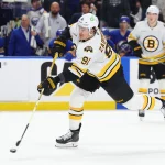 Apr 19, 2026; Buffalo, New York, USA; Boston Bruins defenseman Nikita Zadorov (91) takes a shot on goal during the third period against the Buffalo Sabres in game one of the first round of the 2026 Stanley Cup Playoffs at KeyBank Center. Mandatory Credit: Timothy T. Ludwig-Imagn Images