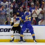 Apr 21, 2026; Buffalo, New York, USA; Boston Bruins center Mark Kastelic (47) and Buffalo Sabres defenseman Logan Stanley (64) fight during the third period in game two of the first round of the 2026 Stanley Cup Playoffs at KeyBank Center. Mandatory Credit: Timothy T. Ludwig-Imagn Images