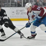 Apr 23, 2026; Los Angeles, California, USA; Los Angeles Kings defenseman Mikey Anderson (44) and Colorado Avalanche center Nathan MacKinnon (29) battle for the puck in the first period of game three of the first round of the 2026 Stanley Cup Playoffs at Crypto.com Arena.