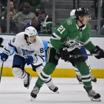 Dec 18, 2024; Dallas, Texas, USA; Toronto Maple Leafs left wing Nicholas Robertson (89) and Dallas Stars left wing Jason Robertson (21) chase the puck during the first period at the American Airlines Center. Mandatory Credit: Jerome Miron-Imagn Images
