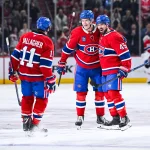 Mar 21, 2026; Montreal, Quebec, CAN; Montreal Canadiens defenseman Kaiden Guhle (21) celebrates with right wing Brendan Gallagher (11) and defenseman Alexandre Carrier (45) his goal against the New York Islanders during the third period at Bell Centre.