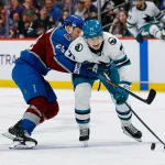 Feb 4, 2026; Denver, Colorado, USA; Colorado Avalanche center Nathan MacKinnon (29) pushes San Jose Sharks center MacKlin Celebrini (71) off the puck in the third period at Ball Arena.