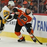 Apr 25, 2026; Philadelphia, Pennsylvania, USA; Philadelphia Flyers right wing Matvei Michkov (39) skates with the puck against Pittsburgh Penguins defenseman Kris Letang (58) during the first period in game four of the first round of the 2026 Stanley Cup Playoffs at Xfinity Mobile Arena.