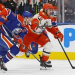 Apr 28, 2026; Edmonton, Alberta, CAN; Edmonton Oilers forward Connor McDavid (97) and Anaheim Ducks forward Chris Kreider (20) chases a loose puck during the second period in game five of the first round of the 2026 Stanley Cup Playoffs at Rogers Place.