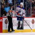 Feb 19, 2023; Denver, Colorado, USA; Edmonton Oilers left wing Warren Foegele (37) argues with referee Eric Furlatt (27) after receiving a penalty in the first period against the Colorado Avalanche at Ball Arena.