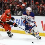 Apr 24, 2026; Anaheim, California, USA; Edmonton Oilers center Connor McDavid (97) controls the puck against Anaheim Ducks center Tim Washe (42) during the first period of game three of the first round of the 2026 Stanley Cup Playoffs at Honda Center.