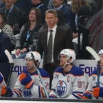 Apr 7, 2026; Salt Lake City, Utah, USA; Edmonton Oilers head coach Kris knoblauch watches play against the Utah Mammoth during the first period at Delta Center.