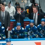 Nov 11, 2025; Vancouver, British Columbia, CAN; Vancouver Canucks assistant coach Kevin Dean and assistant coach Brett McLean and head coach Adam Foote on the bench with forward Kiefer Sherwood (44) and forward Linus Karlsson (94) and forward Arshdeep Bains (13) and forward Max Sasson (63) against the Winnipeg Jets in the third period at Rogers Arena.