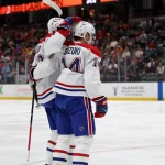 Mar 6, 2026; Anaheim, California, USA; Montreal Canadiens center Nick Suzuki (14) celebrates with defenseman Noah Dobson (left) after scoring a goal against the Anaheim Ducks during the first period at Honda Center.