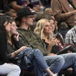 Oct 14, 2022; Montreal, Quebec, CAN; Montreal Canadiens goalie Carey Price (in cowboy hat) and his wife Angela (right) watch the second quarter of the game between the Boston Celtics and the Toronto Raptors at the Bell Centre.